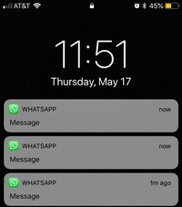 Mobile phone showing WhatsApp notification about a new land listing